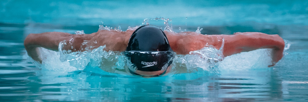 Butterfly swimmer emerges from water