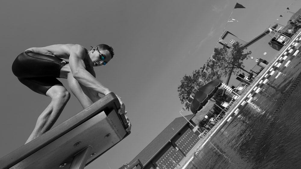 Swimmer on start blocks, monochrome