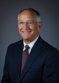 Corporate headshot, grey studio backdrop