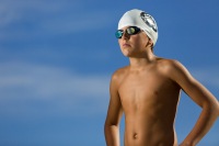 Sportrait of sunlit boy swimmer in goggles