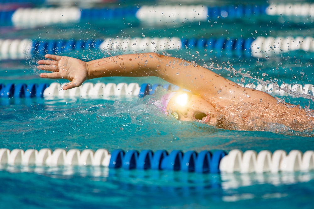 Freestyle swimmer, action shot, goggle reflection