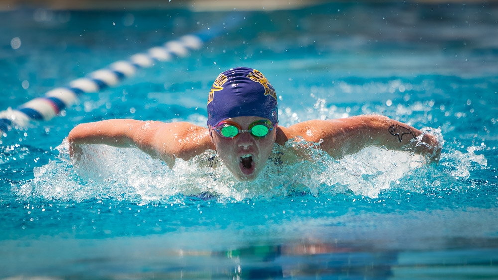 Breaststroke swimmer in purple cap