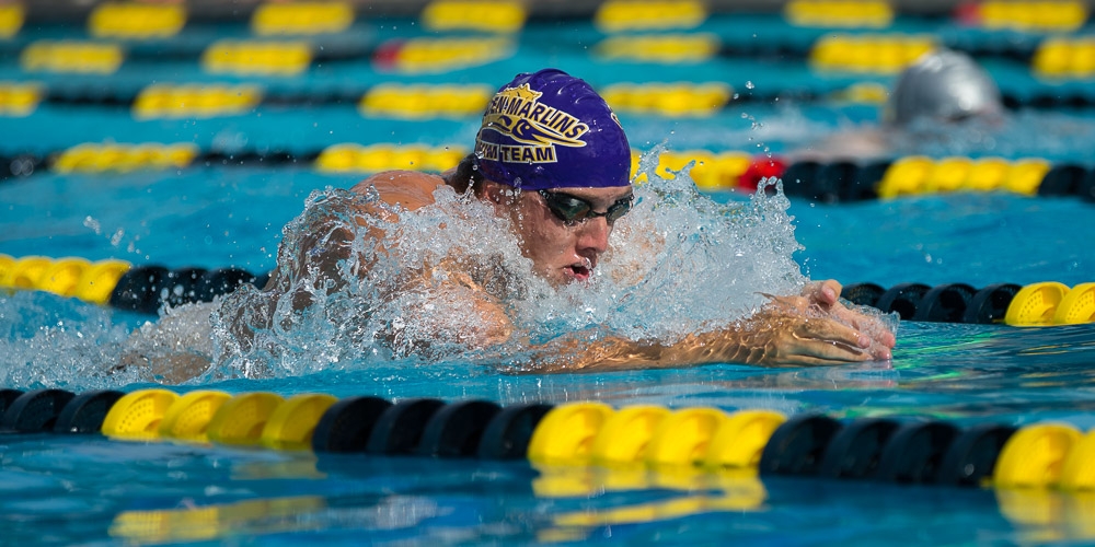 Breaststroke swimmer in purple cap