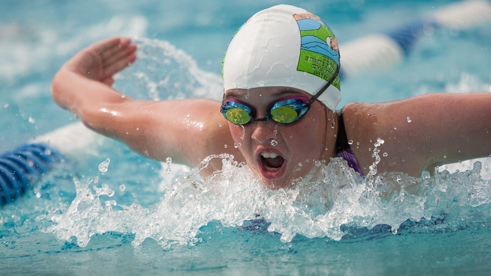 Butterfly swimmer in white cap